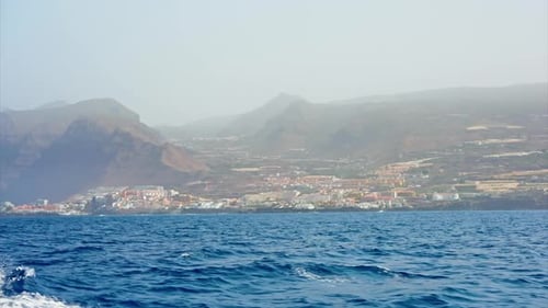 Early morning boat tour along the volcanic rocky coastline of Tenerife, Canary Islands, Spain.