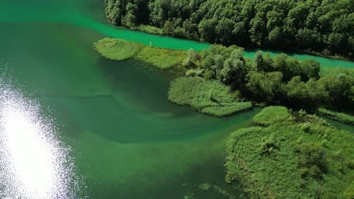 pure green blue waters lake with tiny waves land turquois rivers of flow secluded islands of forests