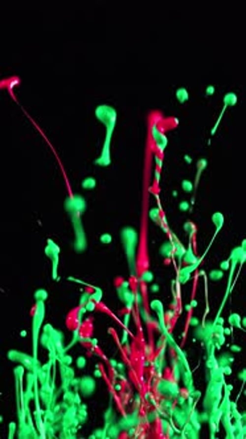 Vivid Surge Of Neon Green And Pink Paints Against Dark Backdrop