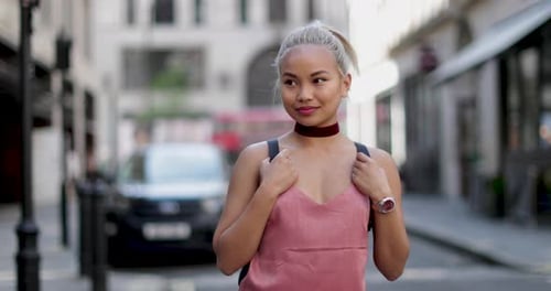 Young Woman Stands on City Street