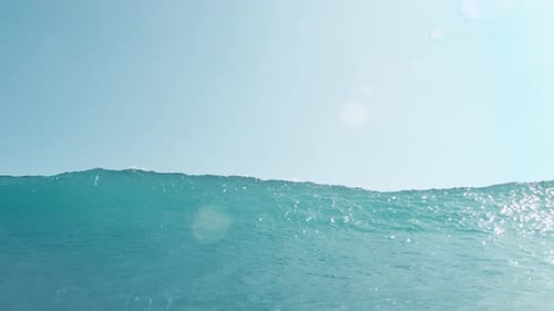 Gentle glistening ocean ripples under soft daylight