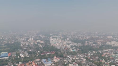 Aerial drone view of Chiang Mai covered in smog during burning season, highlighting severe air