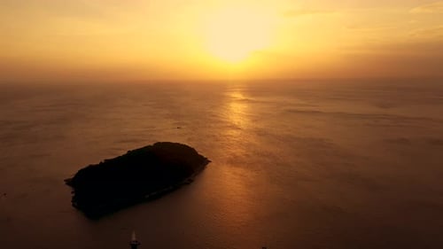 Beautiful bright orange sunset over the Andaman Sea. Aerial. Drone