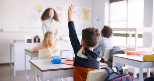 Kids Raising Hands in Elementary School Classroom