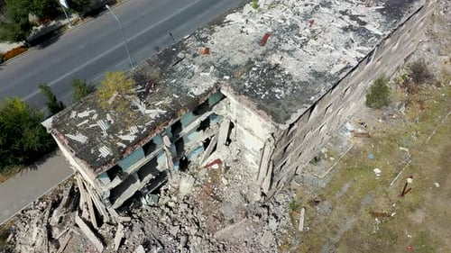 Abandoned, destroyed building aerial view. Drone view building after catastrope, earthquake.