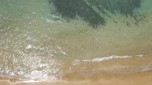Mediterranean beach during summer with people in the water