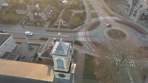 Aerial of church tower in a busy rural town center
