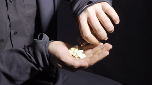 Pills Being Poured into Hand