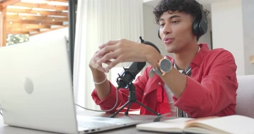 Man Recording Podcast at Home on Laptop