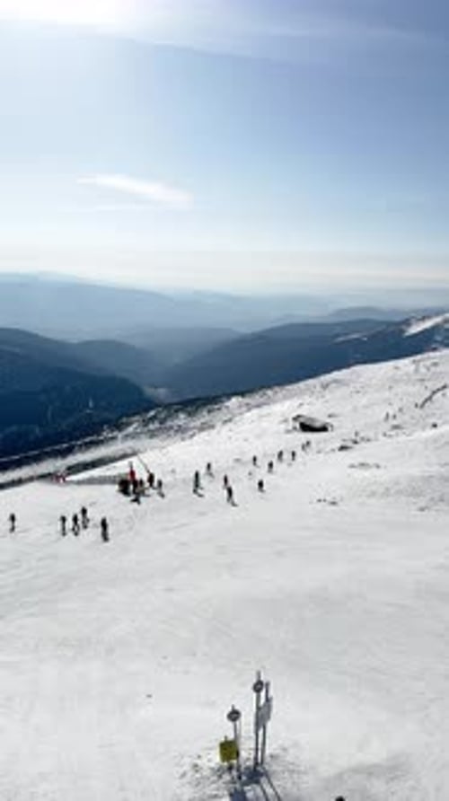 Winter Sports View of Snowcapped Mountains and Ski Slopes on a Sunny Day Skiers Skiing Down the