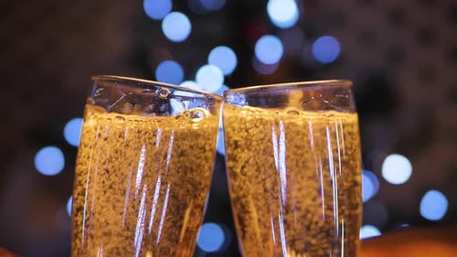 Champagne Toast with Christmas Lights Background