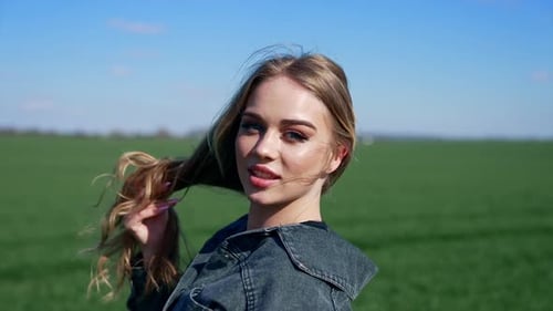 Blonde Woman Posing in a Green Field