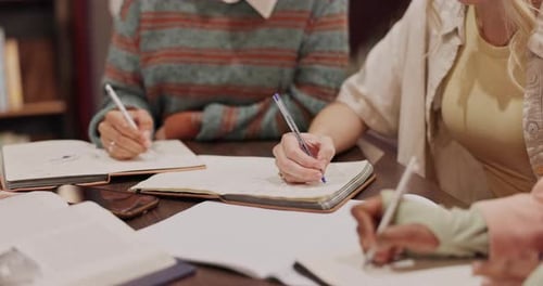 University, library and hands of people with notebook for exam, learning and knowledge in education