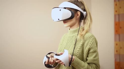 Woman Wearing VR Headset Holding Controllers
