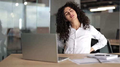 Businesswoman with Back Pain in Office Health Issues at Work