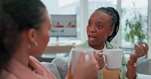 Two Friends Chatting Over Coffee at Home