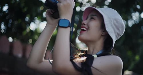 Young Woman Taking Photos in Urban Setting