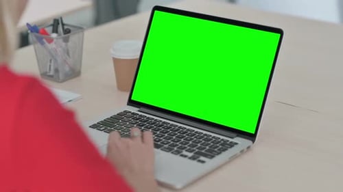 Young Blonde Woman Using Laptop with Green Chroma Key Screen