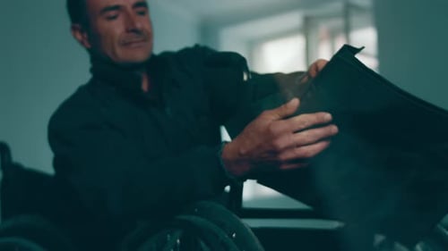A Disabled Man Assembles a Stroller