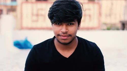 Young Adult Puts on a Black Face Mask