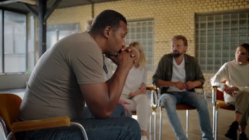 Distraught Man Among Support Group Indoors