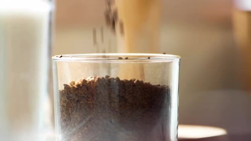 Adding Coffee Granules to a Glass Container