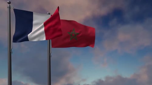 France and Morocco National Flags Waving Against Blue Sky