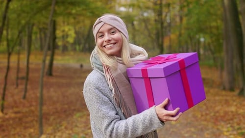 Cheerful Young Lady Walking in Park Dancing