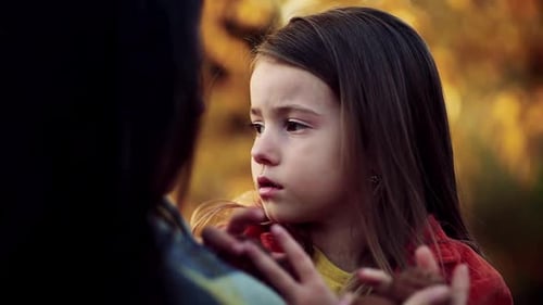 Mother and daughter share tender moment in nature