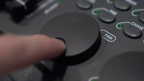 Finger Adjusting Pan Dial on Dark Control Panel