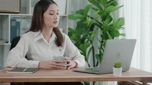Enthusiastic Businesswoman Working and Typing Laptop in the Office
