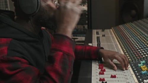 Young Musician Creating New Music in Recording Studio