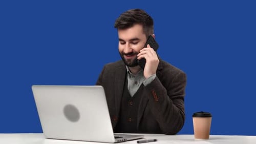 Smiling European Man in Suit Call Smartphone Working Laptop Pc Workplace Desk Chroma Key Blue Screen