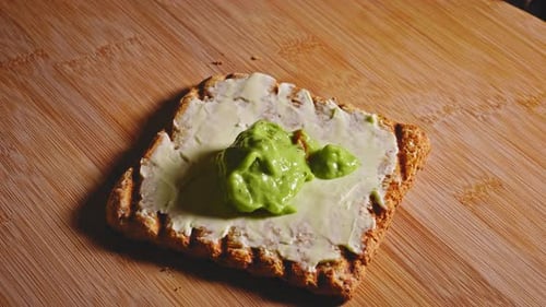 Wholegrain Toast Spread With Cheese And Guacamole. close up