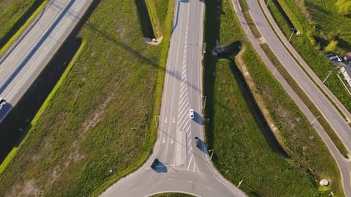one top down over Katlakalns highway interchange with lanes, ramps, roundabout, lively traffic