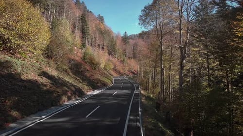 Car driving on winding car road in mountains