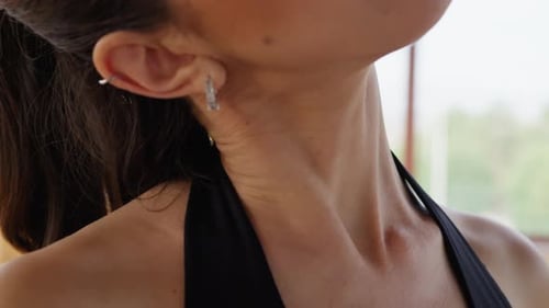 Woman Does Stretching Neck Relaxation Exercise