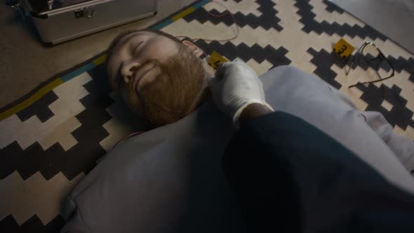 Police Officer Checking Signs of Strangulation of Male Victim at Murder ...