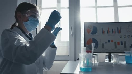 Scientist Examines Liquid in Test Tube in Bright Lab