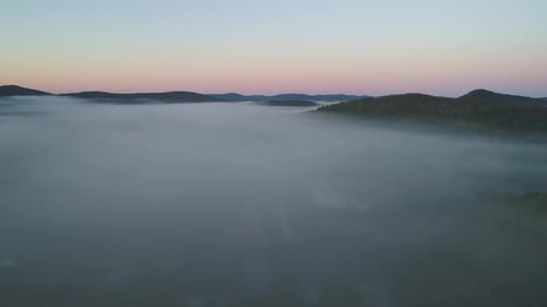Aerial Panoramic Landscape Fog Covers Little Village in the Valley Between the Hills Beautiful