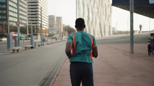 Backview of African American Man Running in the City Training in the Morning