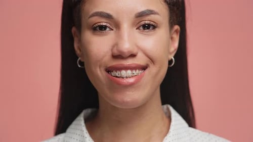 Beautiful Young Woman Smiling Wearing Braces Close-Up