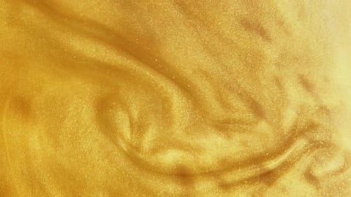 Swirling Glittering Gold Paint Abstract Background