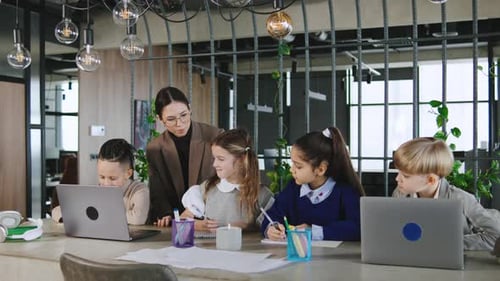 Children Learning with Teacher and Laptop in Office