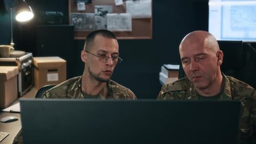Military Officers Observing Data on Computer in Command Center