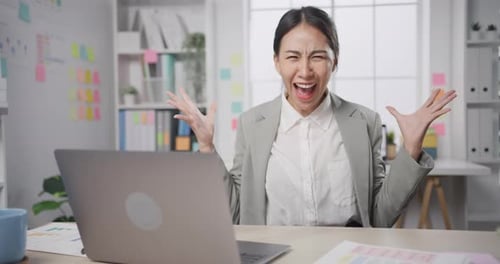 businesswoman crazy with overworked stress angry massive work scream at office.