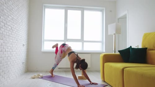 Young Woman Practicing Yoga Fitness at Home