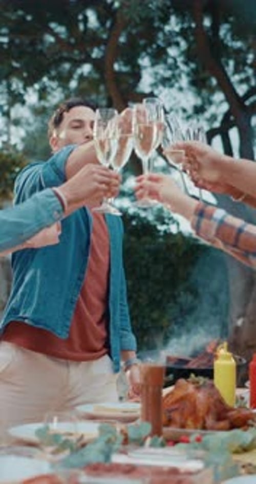 Young Adult Toasting Champagne at Outdoor Celebration