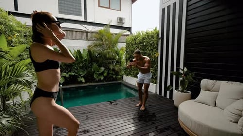 Mixedrace Couple Enjoy Their Villa with Pool Concept of Buying House