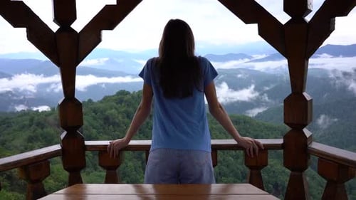 Girl Enjoys the Beautiful Mountain View and Raising Her Hands Up